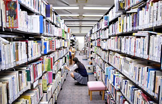 多くの蔵書から本を探す生徒